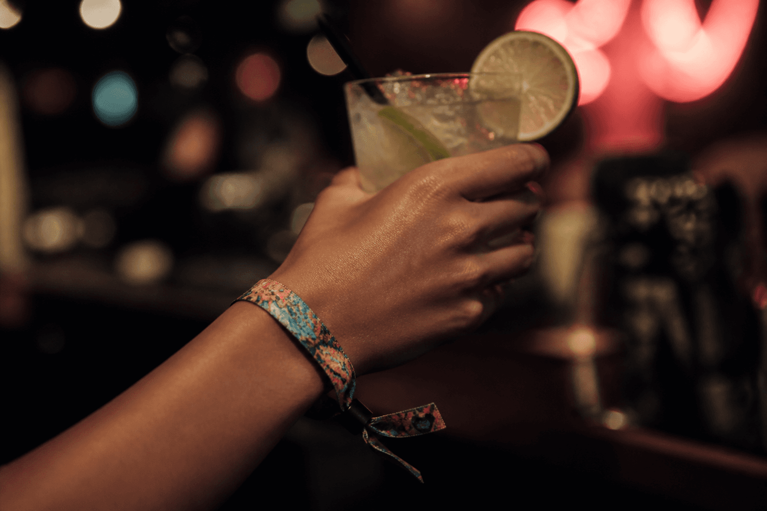 Festival wristband and cocktail in a bar